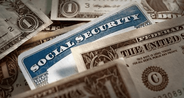 A Social Security card prominently displayed on a background of U.S. currency, illustrating concepts of financial security and identity.