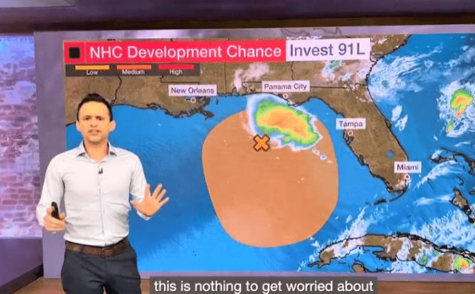 Meteorologist presents a weather map highlighting NHC Development Chance Invest 91L, advising it's not a cause for concern.