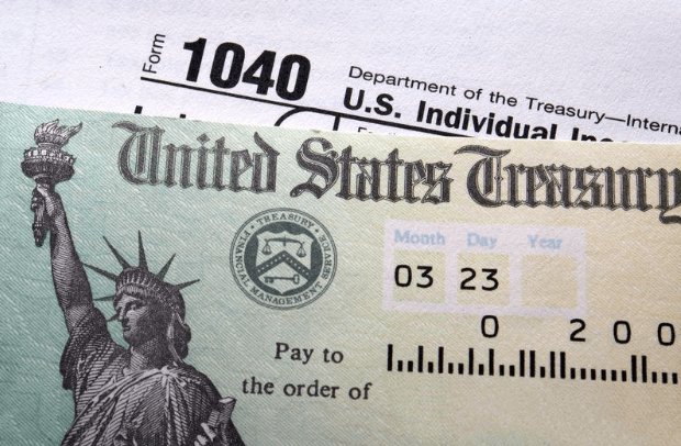 U.S. Treasury check featuring the Statue of Liberty, dated March 2023, alongside a Form 1040 tax document, highlighting tax refund details.