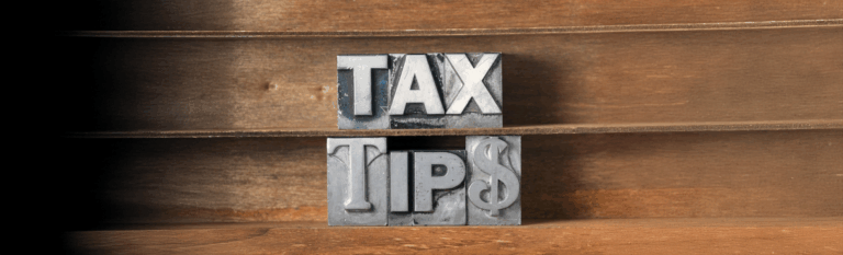 "Bold metal letterpress blocks spelling 'TAX TIPS' on wooden shelves, symbolizing financial advice and tax preparation guidance."